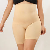 Beige shapewear shorts worn by a person on a plain background